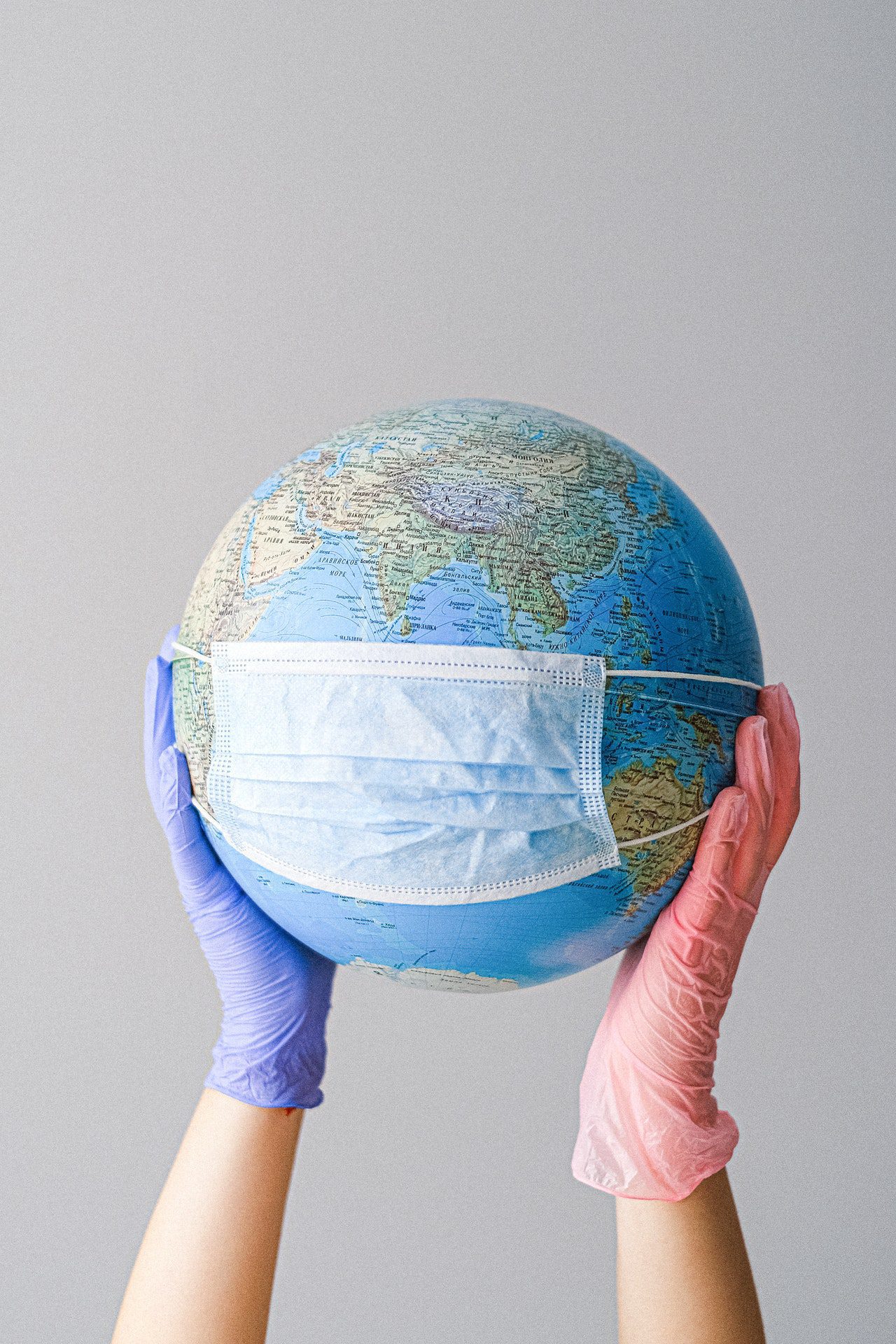 hands-with-latex-gloves-holding-a-globe-with-a-face-mask-4167544 Covid 19 Protocols in effect - Mask Directive